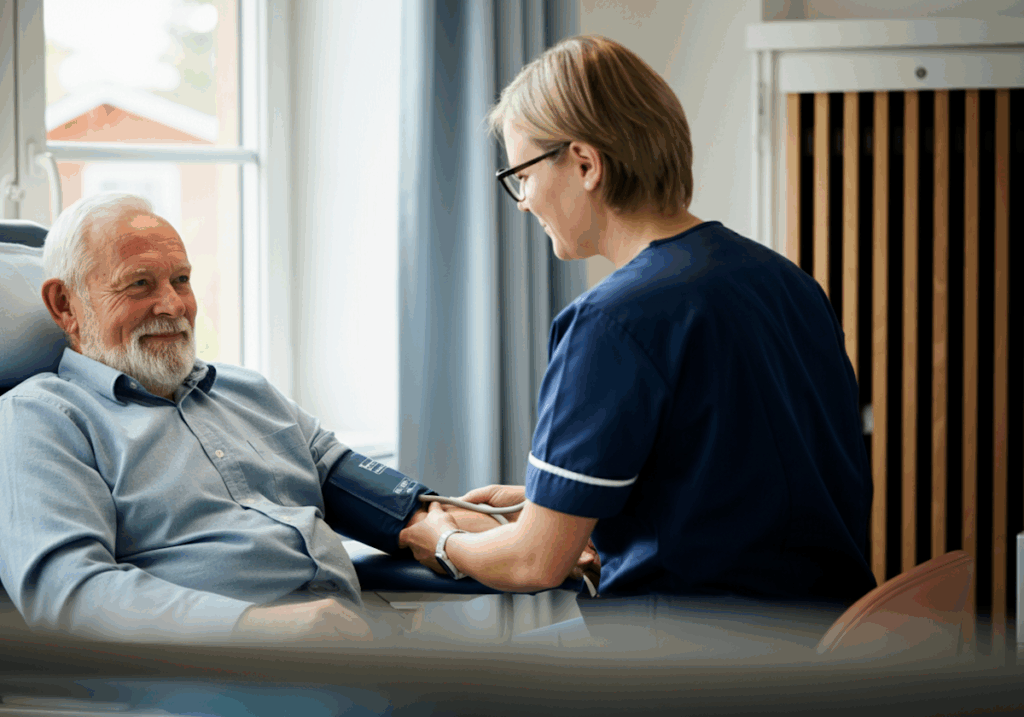 A nurse checks the blood pressure of a smiling elderly man in a bright, comfortable medical setting