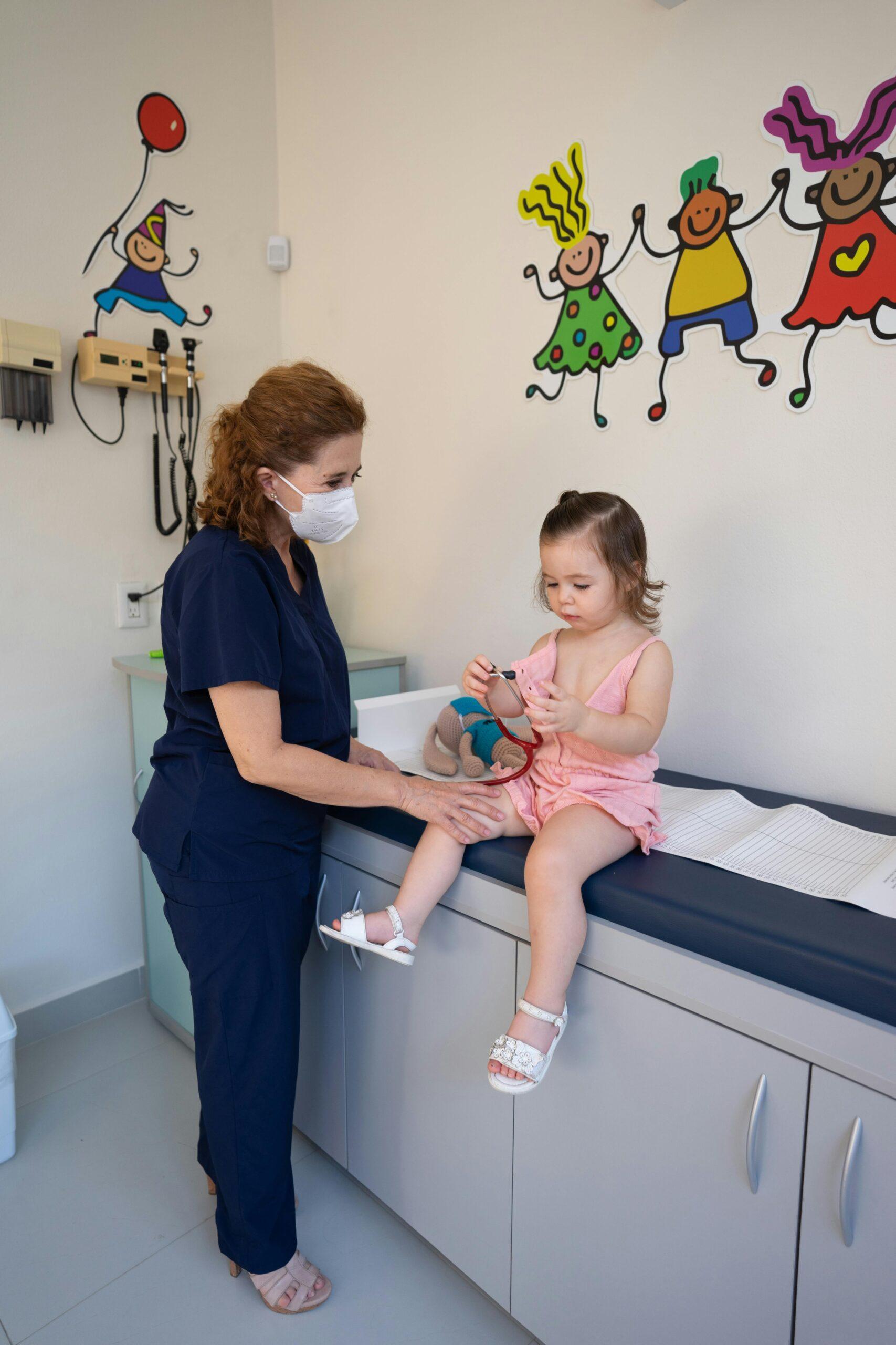 nurse helping toddler