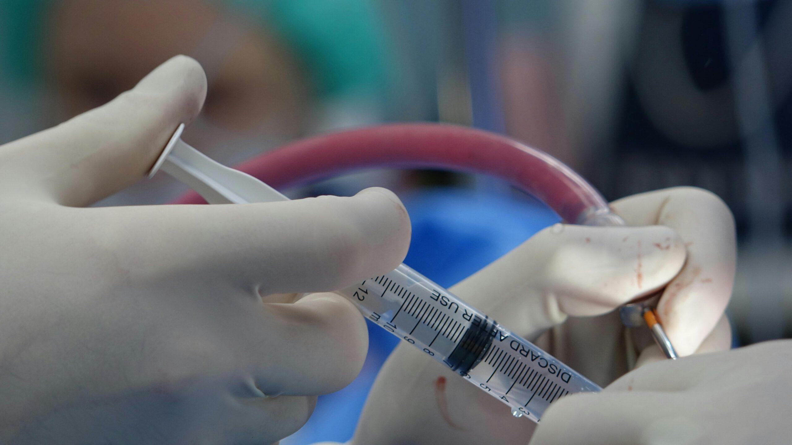 surgeon injecting a patient