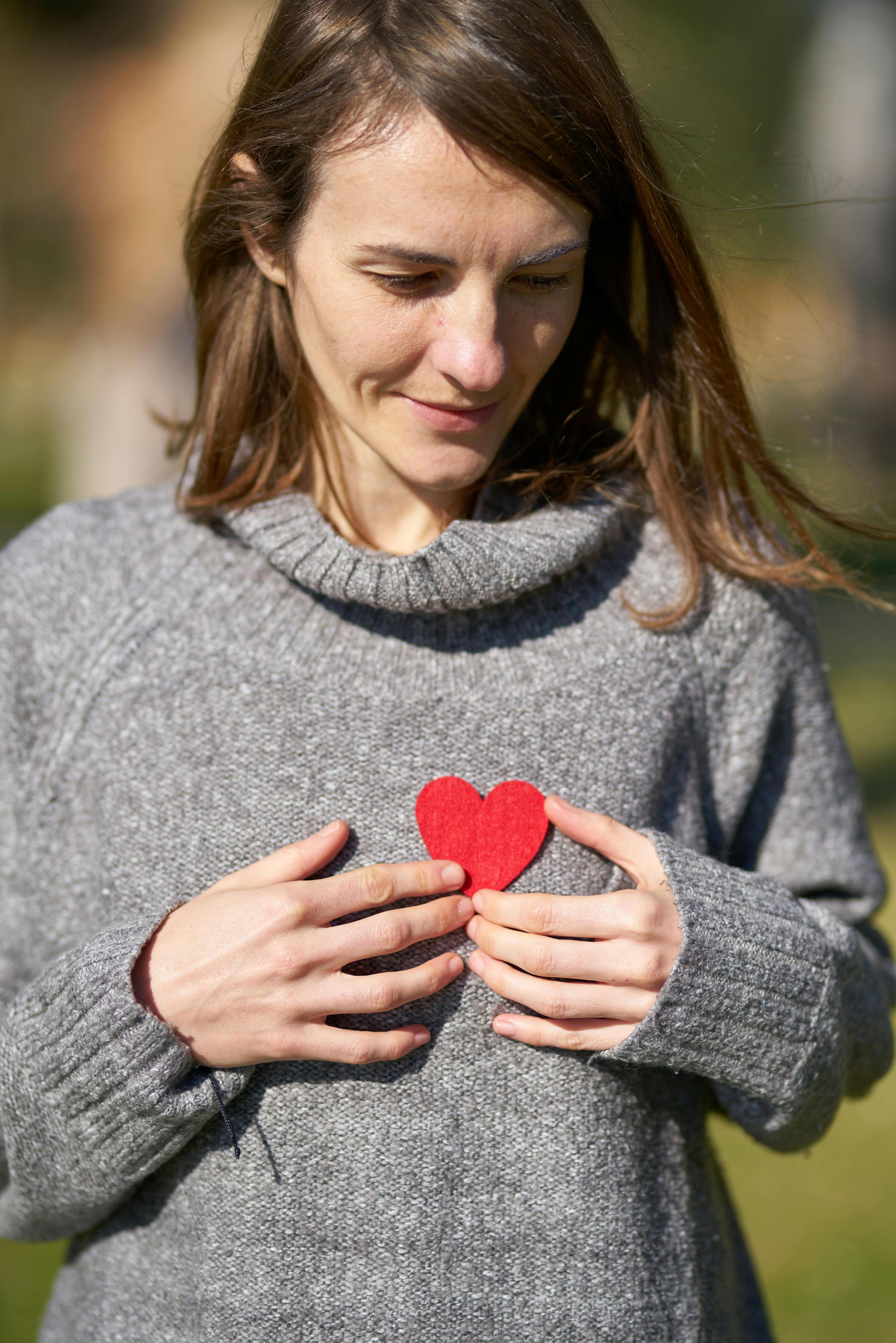 woman holding paper heart