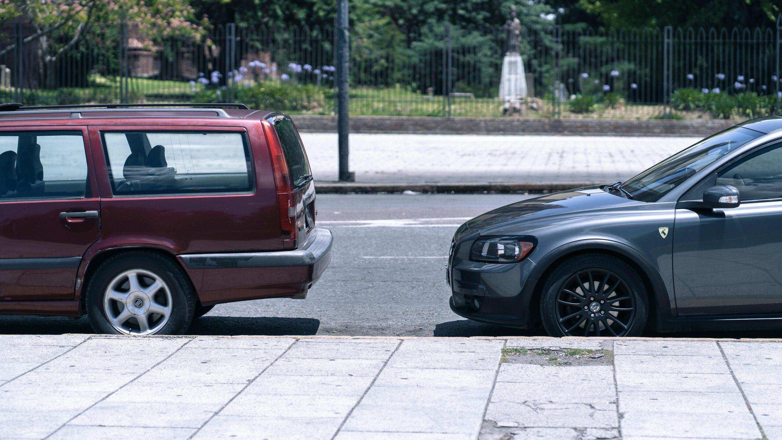 two cars parked at a curb