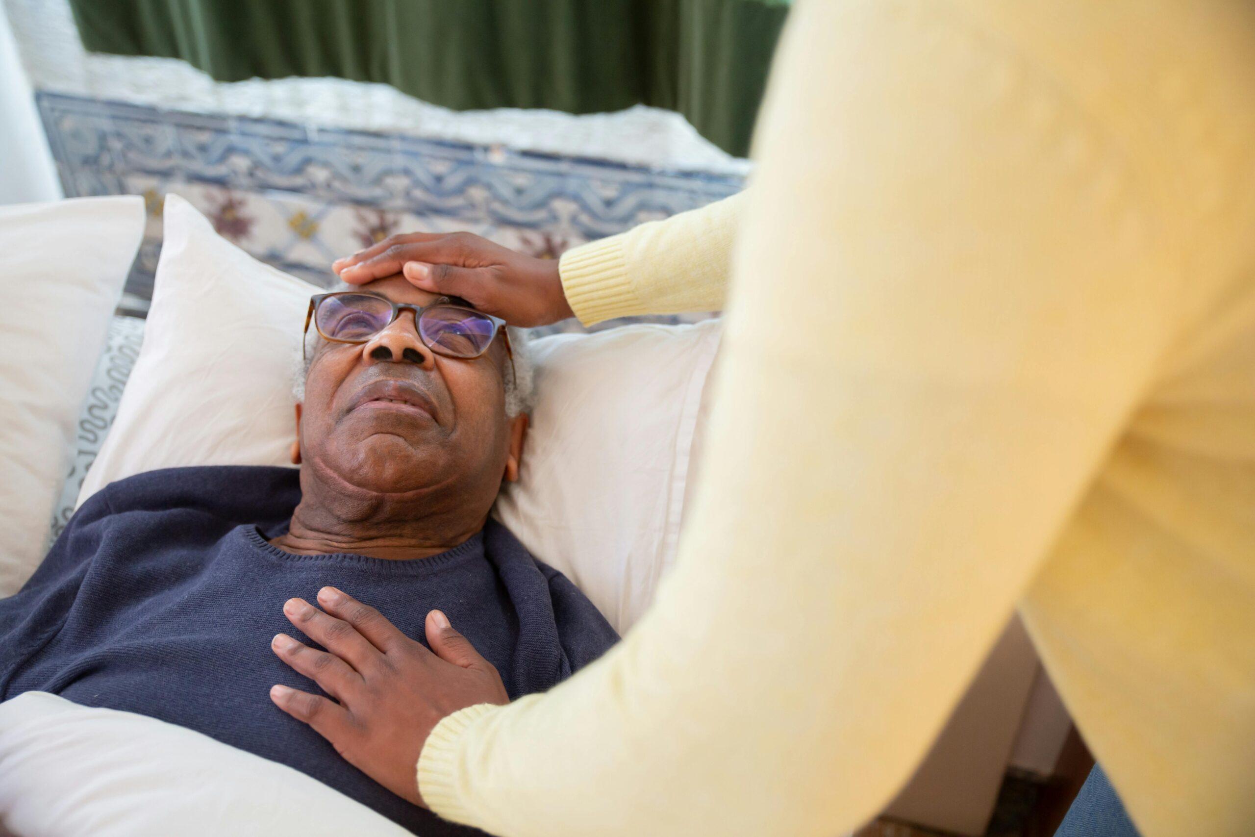 nurse checking on elderly black patient