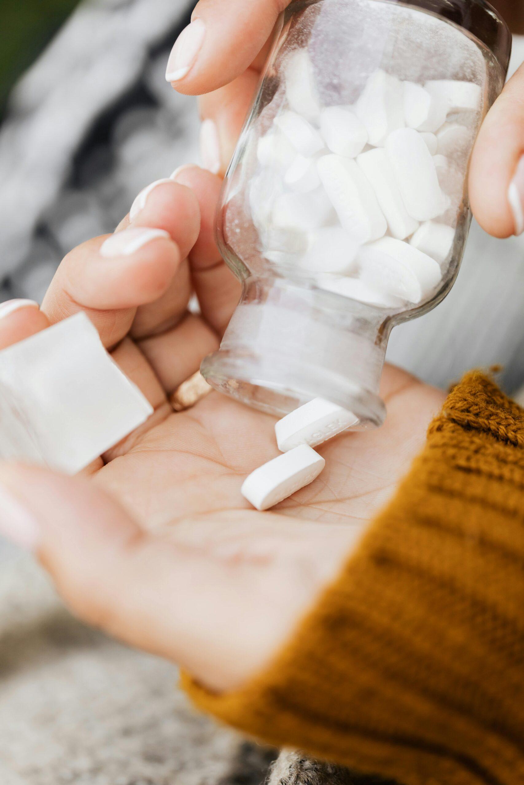 woman pouring pills in her hand