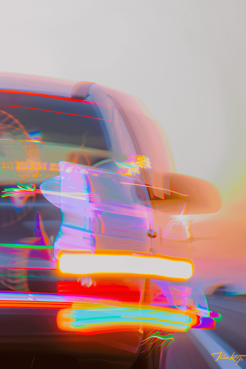 A vibrant long-exposure shot of a car in motion, with colorful light trails and a gradient sunset background.